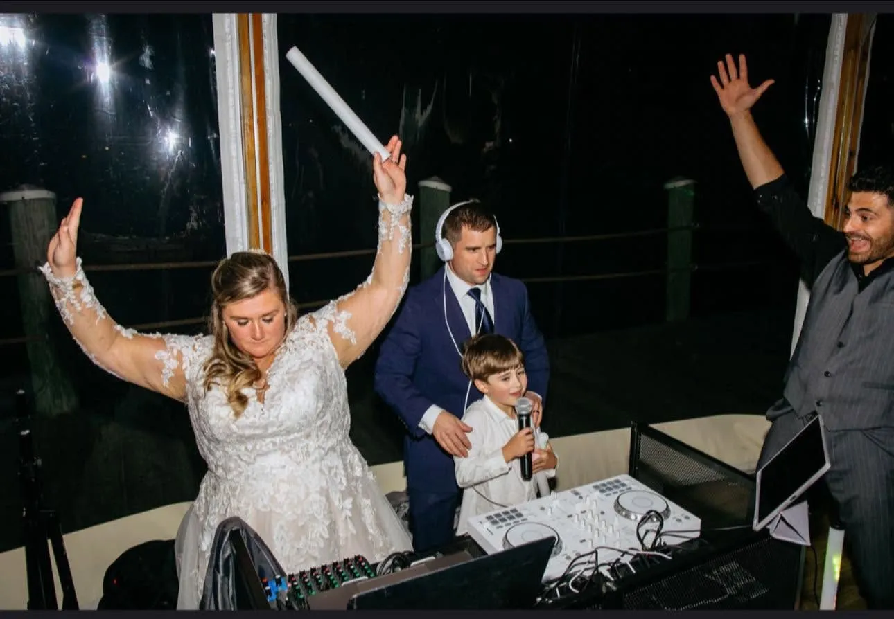 Michael Rossi DJing at an event with professional equipment and warm room lighting